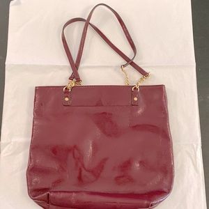 Michael Kors patent leather shoulder bag. 24” handles. Maroon color.